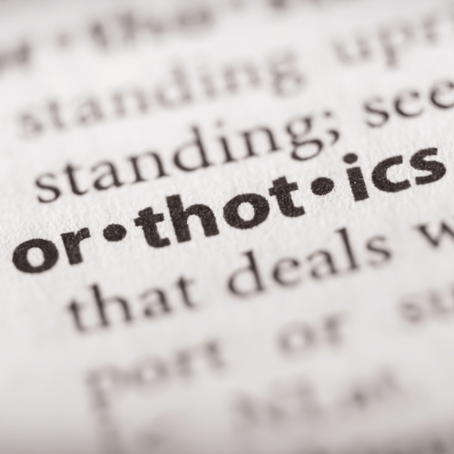 A close up of the word "custom orthotics" in a dictionary.